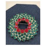 vintage-style wreath brooch features green and