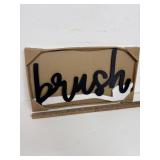 farmhouse-style 'Brush' sign features black