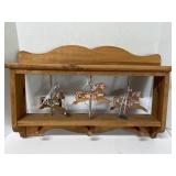 Vintage wooden carousel horse shelf with pegs.