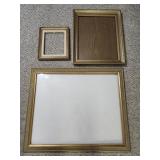 Three golden picture frames with sizes including