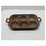 unmarked cast iron 6-cup muffin pan featuring a