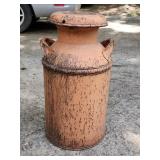 Large orange vintage metal milk can
