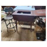 Vintage sewing table with sewing machine inside