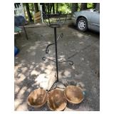 freestanding black metal plant stand and three
