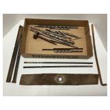 Various used drill bits, rebar, and mower blades