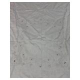 white vintage tablecloth features intricate