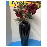 Tall, glossy black decorative vase with florals,
