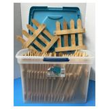 Large plastic tote filled with unfinished wooden