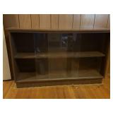 Vintage wood bookcase with glass sliding doors.