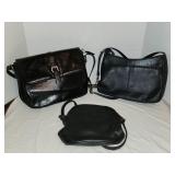 Three classic black faux leather handbags