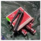 Grease gun with tubes of grease