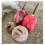 Two plastic and two metal fuel jugs