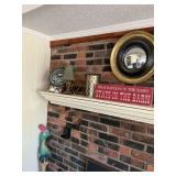 Miscellaneous decor on mantle with parakeet