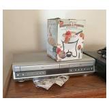 VHS and DVD player, satellite Dish network receiver, miscellaneous speakers, and fondue pot