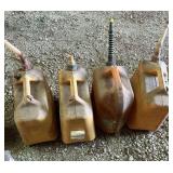 Four plastic fuel jugs