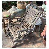 Vintage platform rocker with patio furniture and fountain