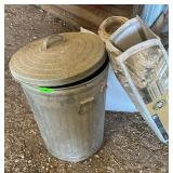 Metal trashcan and plastic sheeting