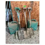 Four wooden handled shovels and two 6 gallon jugs