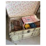 Antique trunk with toys and folding chair