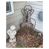 Iron patio chair with concrete statue