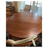Wooden kitchen table with captain chairs