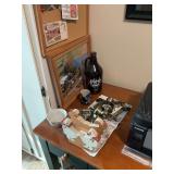 Contents on top of desk including pictures
