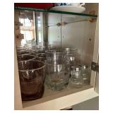 Three shelves of glass drinking glasses