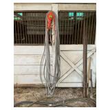 Hoses, trouble light, and two fence posts