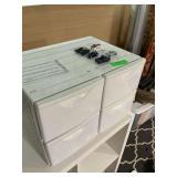 Four plastic storage drawers with miniature toy cars