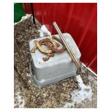 Horseshoes, plant stand, and propane bottle