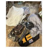 Assorted tarps, stroller, popcorn popper, Dewalt bag, and American flag