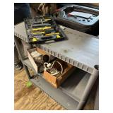 Plastic shelving unit with tool kit, catalytic converter and power strip