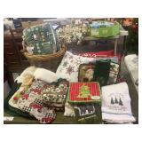 Collection of Christmas Themed Textiles and Decorative Pillows in Wicker Basket