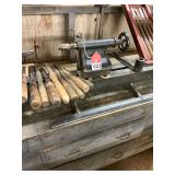 Heston and Anderson wood lathe made about 1946, modified to turn up to 11 inch stock, variable speed by belt and pulley, 2 sets of turning tools with wood bench included
