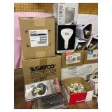 1 case of 175 watt dusk to dawn bulbs, 2 Tripp Lite power bars, 1 case of Satco 120 volt 9.5 watt LED bulbs, 1 case of Satco 15 watt LED bulbs medium base, 2 - 125 amp main lug disconnects + more