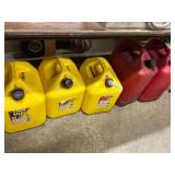 3 plastic kerosene cans and 2 gas cans