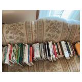 Assortment of cookbooks, health books, and copy paper