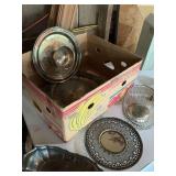 Candleholders, metal kitchenware, and small dinner bell