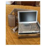 Magnavox portable DVD player and wicker basket with grapes of wrath