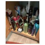 Contents below the sink, hair products, mirror, skin care