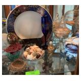 Second shelf of curio cabinet -candy dishes with marbles, plates, & small figurines