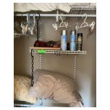 Contents of closet - plastic shelving, pillows, hangers, water repellent spray for shoes