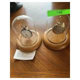 Two antique pocket watches on stands