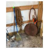 Contents of wall, including rope, brooms, jumper cables