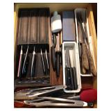 Drawer of kitchen knives and tongs