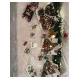 2 lighted villages with various figures frolicking in the snow