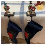 2 cast iron mantel stocking holders with 2 large stockings