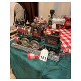 Mr. Christmas locomotive that is stationary but wheels spin, figurine shovels coal and plays both Christmas songs but also Railroad songs, working on the railroad etc. w/box