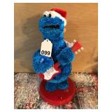 Cookie Monster dances and plays his guitar and growls Christmas songs