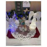 2 glass angels with both having lights and a candle, beautiful angels